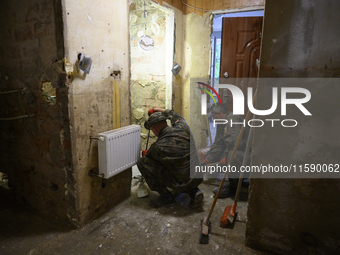 Members of the Polish armed forces clean up a house after the flood in Glucholazy, Poland, on September 20, 2024. (