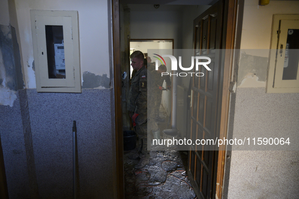 Members of the Polish armed forces clean up a house after the flood in Glucholazy, Poland, on September 20, 2024. 