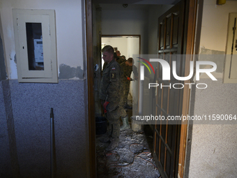 Members of the Polish armed forces clean up a house after the flood in Glucholazy, Poland, on September 20, 2024. (