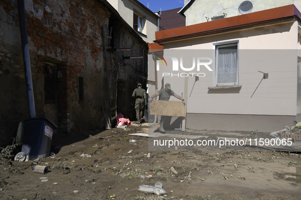 Members of the Polish armed forces remove debris from flood-hit houses in Glucholazy, Poland, on September 20, 2024. 