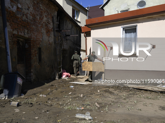 Members of the Polish armed forces remove debris from flood-hit houses in Glucholazy, Poland, on September 20, 2024. (