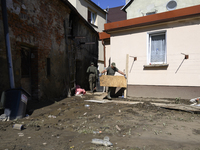 Members of the Polish armed forces remove debris from flood-hit houses in Glucholazy, Poland, on September 20, 2024. (