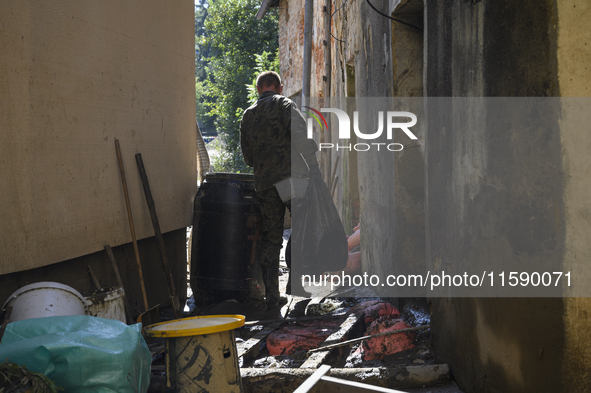 Members of the Polish armed forces remove debris from flood-hit houses in Glucholazy, Poland, on September 20, 2024. 