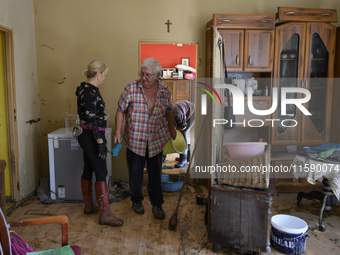 People clean up their apartment after the flood in Glucholazy, Poland, on September 20, 2024. (