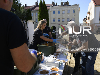 An elderly man receives food in the flood-hit town of Glucholazy, Poland, on September 20, 2024. (