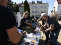 An elderly man receives food in the flood-hit town of Glucholazy, Poland, on September 20, 2024. (