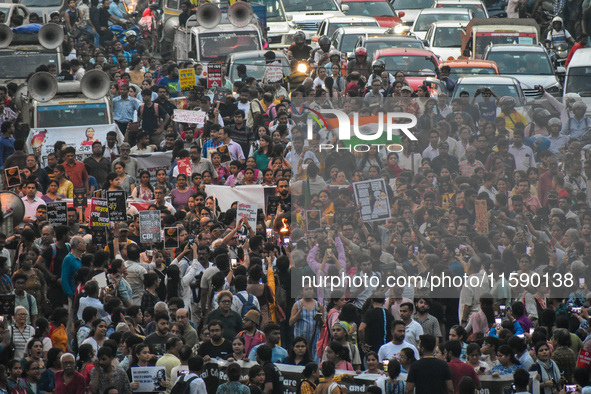 Various citizen organizations take out a torch rally in Kolkata, India, on September 20, 2024, in protest against the rape and murder of a s...