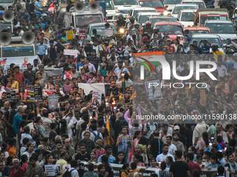 Various citizen organizations take out a torch rally in Kolkata, India, on September 20, 2024, in protest against the rape and murder of a s...