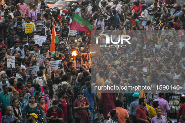 Various citizen organizations take out a torch rally in Kolkata, India, on September 20, 2024, in protest against the rape and murder of a s...