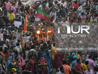 Various citizen organizations take out a torch rally in Kolkata, India, on September 20, 2024, in protest against the rape and murder of a s...