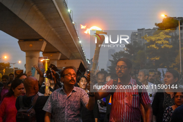 Various citizen organizations take out a torch rally in Kolkata, India, on September 20, 2024, in protest against the rape and murder of a s...