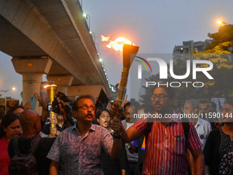 Various citizen organizations take out a torch rally in Kolkata, India, on September 20, 2024, in protest against the rape and murder of a s...