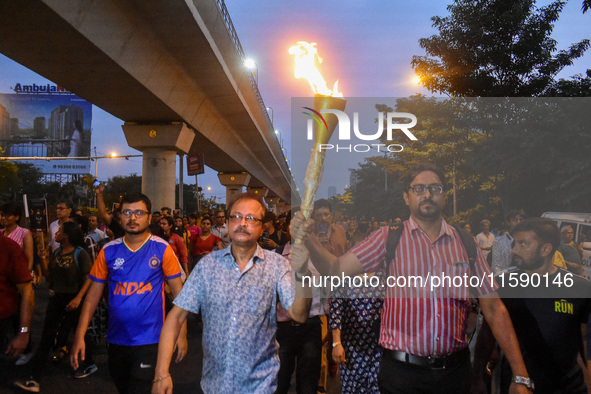 Various citizen organizations take out a torch rally in Kolkata, India, on September 20, 2024, in protest against the rape and murder of a s...