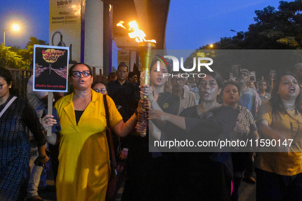 Various citizen organizations take out a torch rally in Kolkata, India, on September 20, 2024, in protest against the rape and murder of a s...