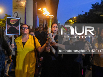 Various citizen organizations take out a torch rally in Kolkata, India, on September 20, 2024, in protest against the rape and murder of a s...