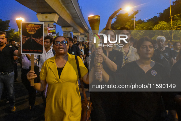 Various citizen organizations take out a torch rally in Kolkata, India, on September 20, 2024, in protest against the rape and murder of a s...