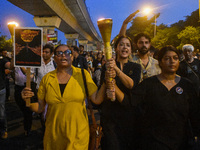 Various citizen organizations take out a torch rally in Kolkata, India, on September 20, 2024, in protest against the rape and murder of a s...