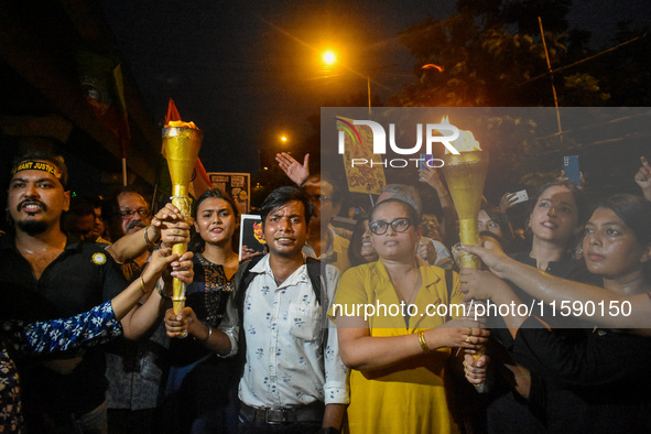 Various citizen organizations take out a torch rally in Kolkata, India, on September 20, 2024, in protest against the rape and murder of a s...