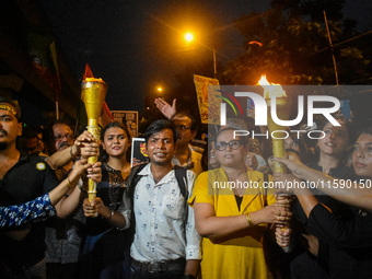 Various citizen organizations take out a torch rally in Kolkata, India, on September 20, 2024, in protest against the rape and murder of a s...