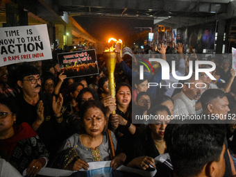 Various citizen organizations take out a torch rally in Kolkata, India, on September 20, 2024, in protest against the rape and murder of a s...