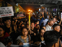 Various citizen organizations take out a torch rally in Kolkata, India, on September 20, 2024, in protest against the rape and murder of a s...