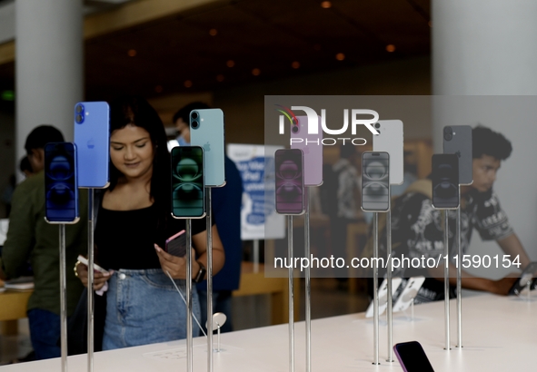 Customers browse iPhone 16 on the launch day of the iPhone 16 series at Apple BKC, in Mumbai, India, on September 20, 2024. The highly await...