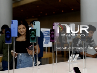 Customers browse iPhone 16 on the launch day of the iPhone 16 series at Apple BKC, in Mumbai, India, on September 20, 2024. The highly await...