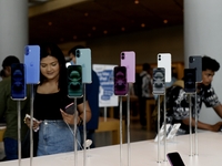 Customers browse iPhone 16 on the launch day of the iPhone 16 series at Apple BKC, in Mumbai, India, on September 20, 2024. The highly await...