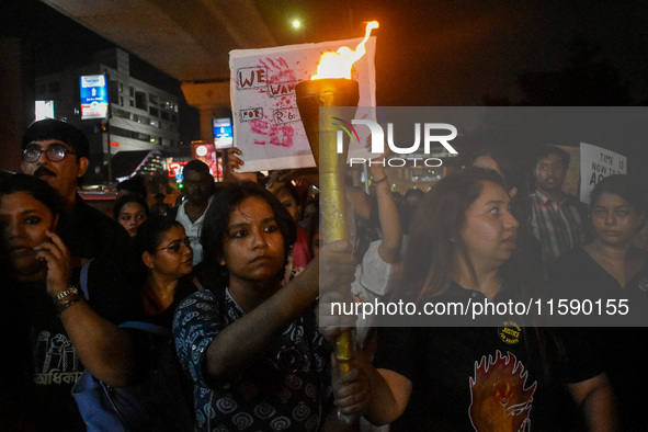 Various citizen organizations take out a torch rally in Kolkata, India, on September 20, 2024, in protest against the rape and murder of a s...