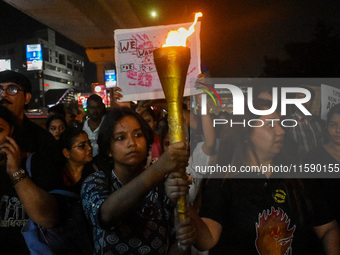 Various citizen organizations take out a torch rally in Kolkata, India, on September 20, 2024, in protest against the rape and murder of a s...