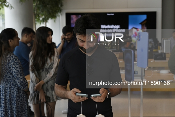 Customers browse iPhone 16 on the launch day of the iPhone 16 series at Apple BKC, in Mumbai, India, on September 20, 2024. The highly await...