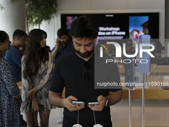 Customers browse iPhone 16 on the launch day of the iPhone 16 series at Apple BKC, in Mumbai, India, on September 20, 2024. The highly await...