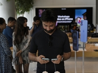 Customers browse iPhone 16 on the launch day of the iPhone 16 series at Apple BKC, in Mumbai, India, on September 20, 2024. The highly await...