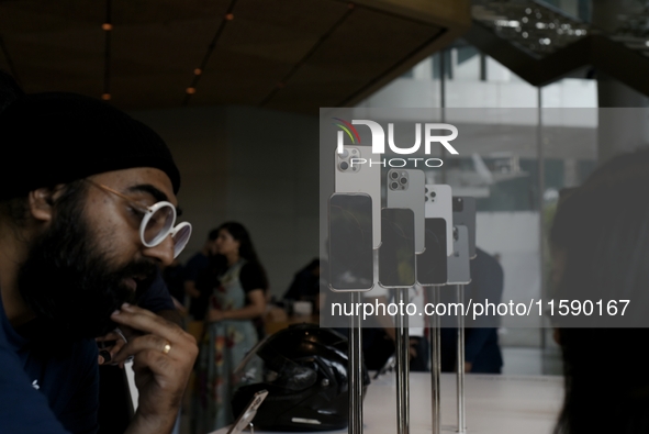 Customers browse iPhone 16 on the launch day of the iPhone 16 series at Apple BKC, in Mumbai, India, on September 20, 2024. The highly await...