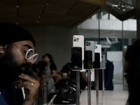 Customers browse iPhone 16 on the launch day of the iPhone 16 series at Apple BKC, in Mumbai, India, on September 20, 2024. The highly await...