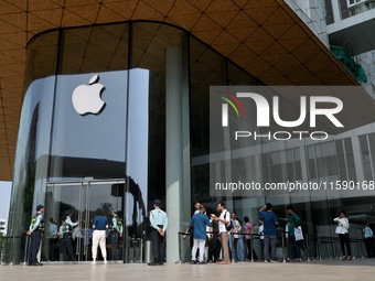 Customers stand in line on the launch day of the iPhone 16 series at Apple BKC, in Mumbai, India, on September 20, 2024. The iPhone 16 serie...