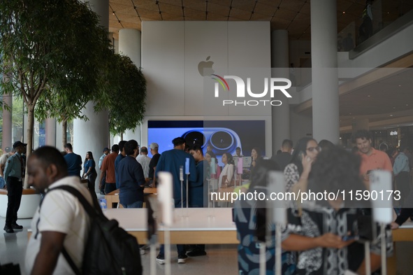 Customers sit inside a store on the launch day of the iPhone 16 series at Apple BKC, in Mumbai, India, on September 20, 2024. The highly awa...