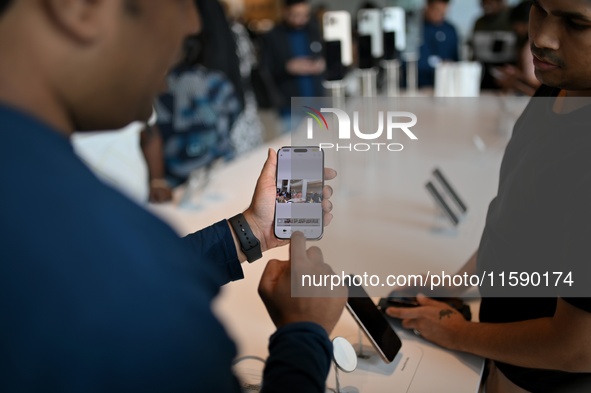 Customers browse iPhone 16 on the launch day of the iPhone 16 series at Apple BKC, in Mumbai, India, on September 20, 2024. The highly await...