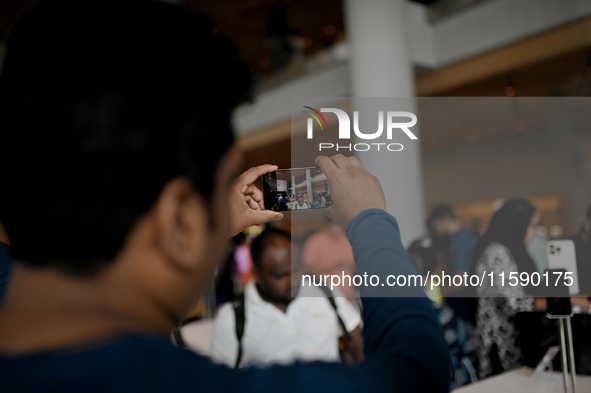 Customers browse iPhone 16 on the launch day of the iPhone 16 series at Apple BKC, in Mumbai, India, on September 20, 2024. The highly await...