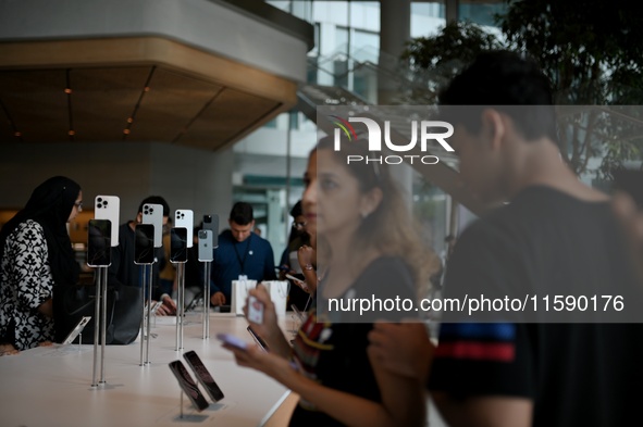 Customers browse iPhone 16 on the launch day of the iPhone 16 series at Apple BKC, in Mumbai, India, on September 20, 2024. The highly await...