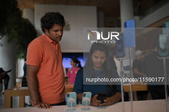 Customers browse iPhone 16 on the launch day of the iPhone 16 series at Apple BKC, in Mumbai, India, on September 20, 2024. The highly await...