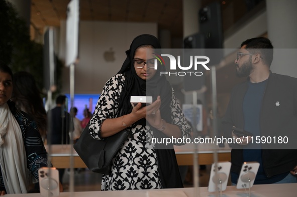 Customers browse iPhone 16 on the launch day of the iPhone 16 series at Apple BKC, in Mumbai, India, on September 20, 2024. The highly await...