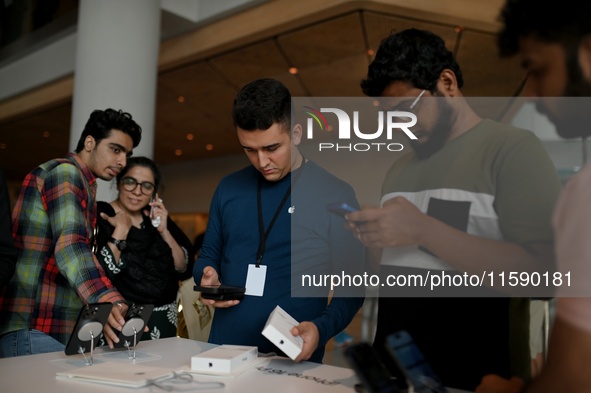 Customers browse iPhone 16 on the launch day of the iPhone 16 series at Apple BKC, in Mumbai, India, on September 20, 2024. The highly await...