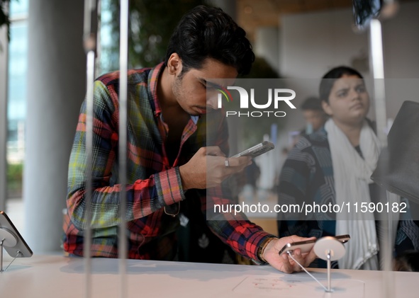 Customers browse iPhone 16 on the launch day of the iPhone 16 series at Apple BKC, in Mumbai, India, on September 20, 2024. The highly await...