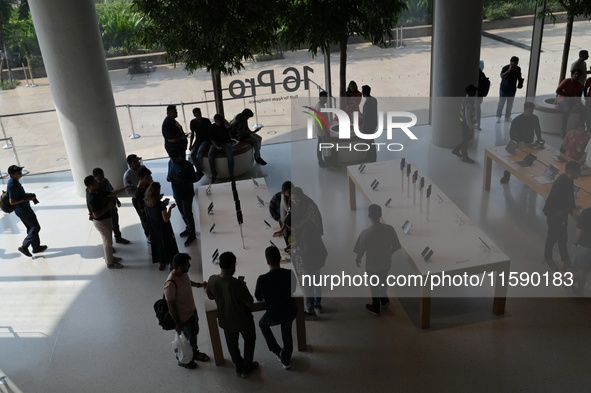 Customers browse iPhone 16 on the launch day of the iPhone 16 series at Apple BKC, in Mumbai, India, on September 20, 2024. The highly await...