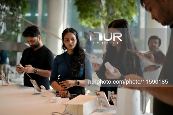 Customers browse iPhone 16 on the launch day of the iPhone 16 series at Apple BKC, in Mumbai, India, on September 20, 2024. The highly await...