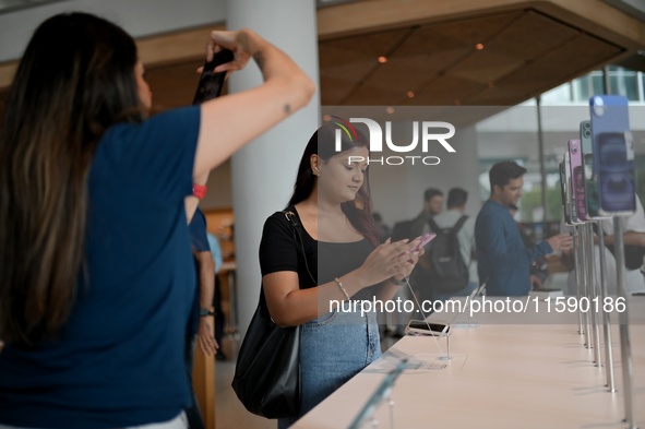 Customers browse iPhone 16 on the launch day of the iPhone 16 series at Apple BKC, in Mumbai, India, on September 20, 2024. The highly await...