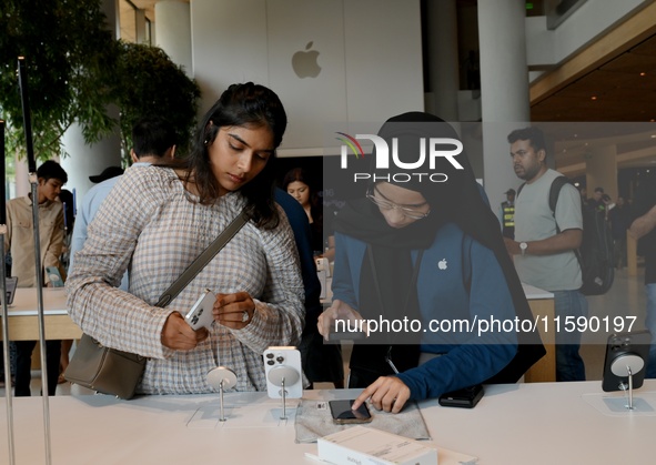 Customers browse iPhone 16 on the launch day of the iPhone 16 series at Apple BKC, in Mumbai, India, on September 20, 2024. The highly await...