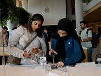 Customers browse iPhone 16 on the launch day of the iPhone 16 series at Apple BKC, in Mumbai, India, on September 20, 2024. The highly await...