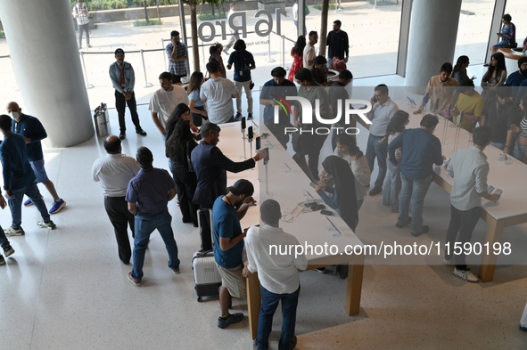 Customers browse iPhone 16 on the launch day of the iPhone 16 series at Apple BKC, in Mumbai, India, on September 20, 2024. The highly await...